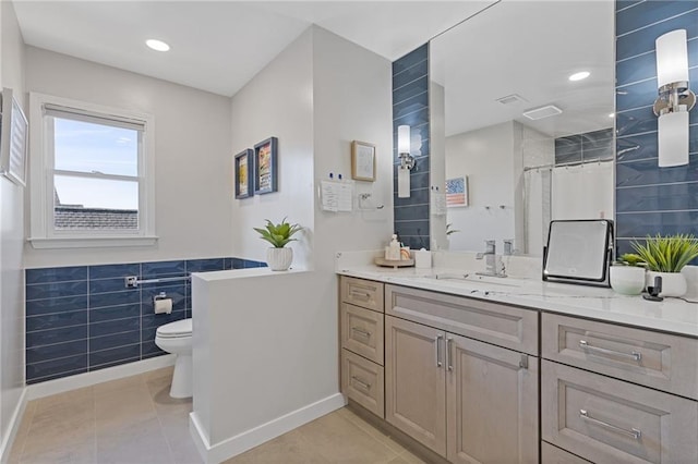 bathroom with a shower with curtain, vanity, tile patterned floors, and toilet