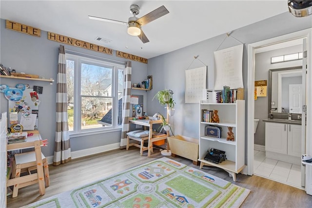 rec room featuring ceiling fan and light hardwood / wood-style flooring