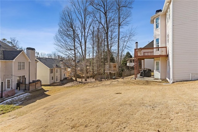 view of yard featuring a wooden deck and a patio