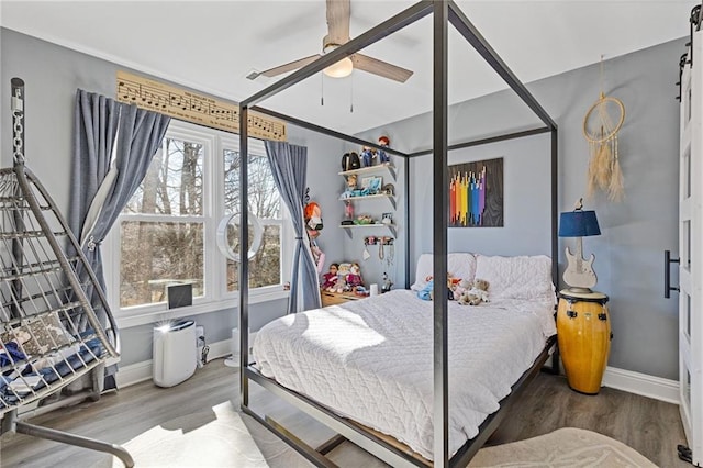 bedroom featuring hardwood / wood-style floors and ceiling fan