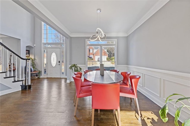 dining space featuring ornamental molding, a healthy amount of sunlight, and dark hardwood / wood-style flooring