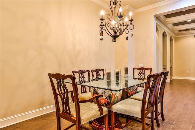 dining space with beam ceiling, dark hardwood / wood-style floors, crown molding, and a notable chandelier