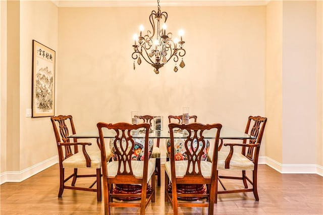 dining area featuring wood-type flooring and an inviting chandelier