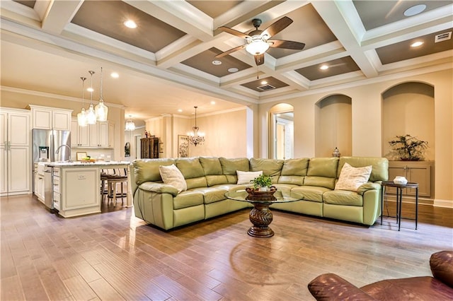 living room featuring beam ceiling, light wood-type flooring, ornamental molding, and coffered ceiling