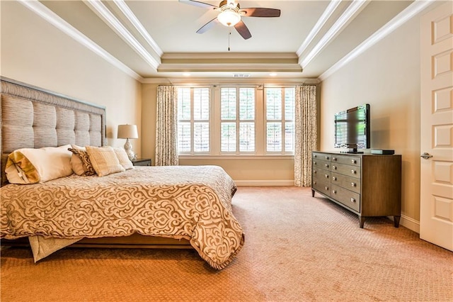 carpeted bedroom with a raised ceiling, ceiling fan, and crown molding