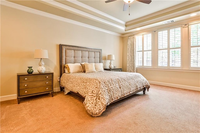 carpeted bedroom with a raised ceiling, ceiling fan, and crown molding