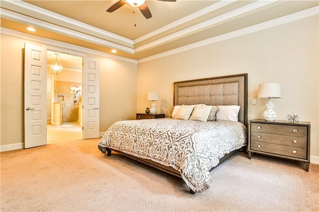 carpeted bedroom featuring connected bathroom, a raised ceiling, ceiling fan, and crown molding