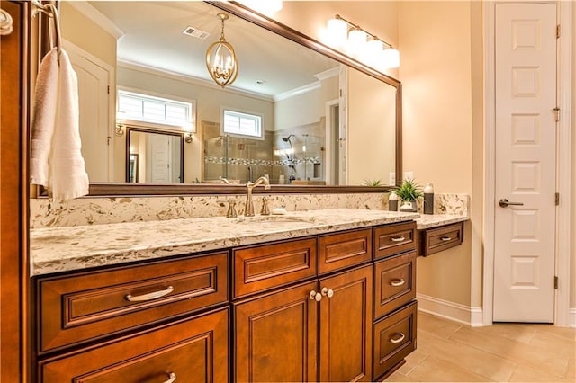 bathroom with vanity, an inviting chandelier, tile patterned floors, crown molding, and tiled shower