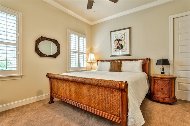 carpeted bedroom with ceiling fan and ornamental molding