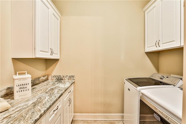 washroom with light tile patterned flooring, cabinets, and separate washer and dryer