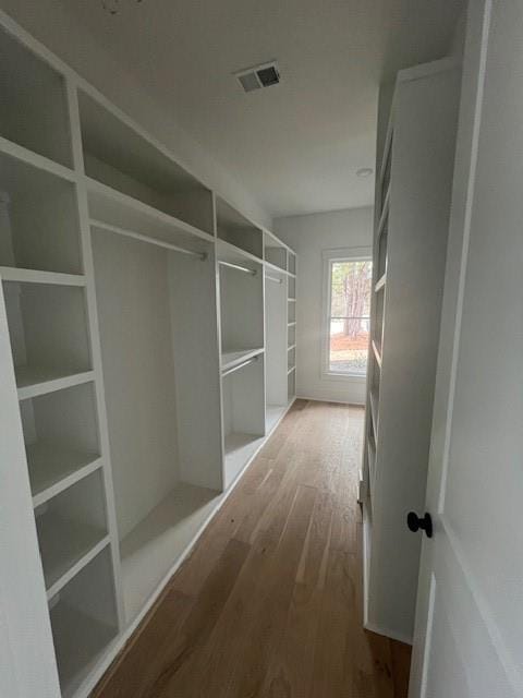 spacious closet with visible vents and wood finished floors