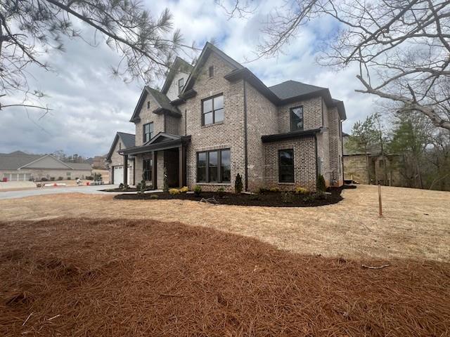 view of home's exterior featuring a garage and brick siding