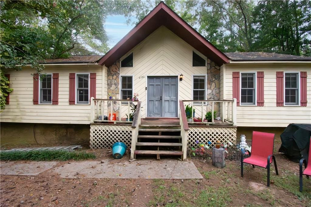 back of property with a wooden deck