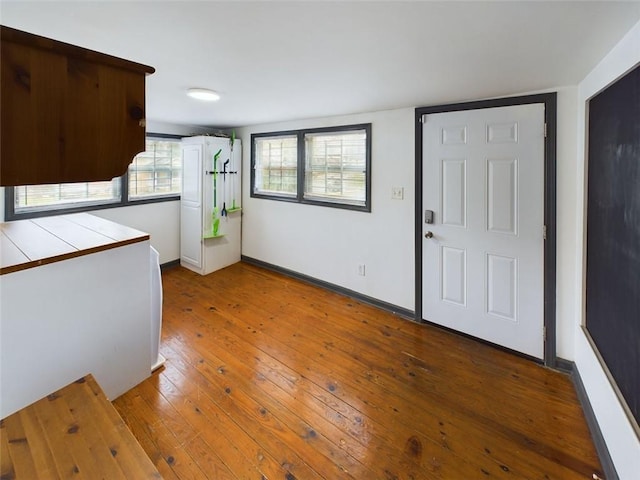 kitchen featuring white cabinetry, hardwood / wood-style flooring, and tile counters