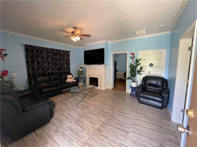 living room featuring crown molding, a brick fireplace, and ceiling fan