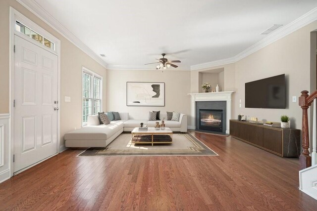 living room with crown molding, hardwood / wood-style floors, and ceiling fan