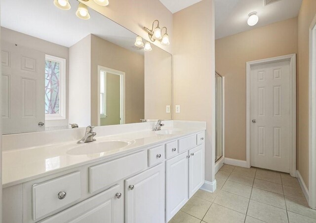 bathroom featuring vanity, tile patterned floors, and an enclosed shower