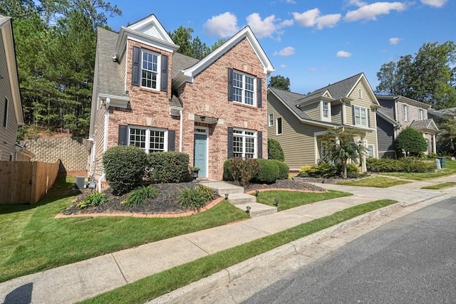 view of front of house with a front yard and central air condition unit