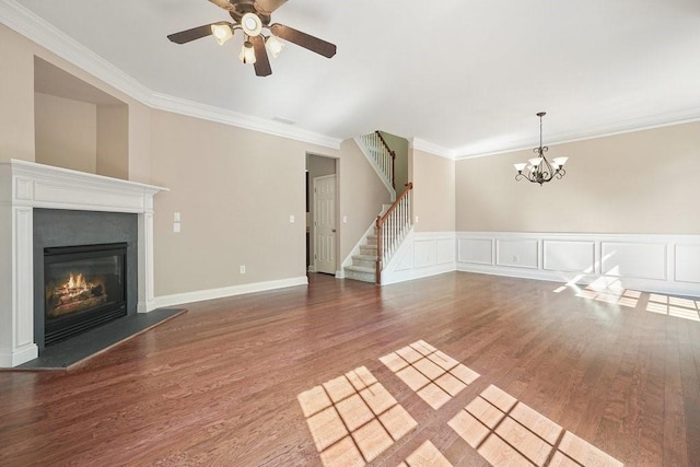 unfurnished living room with ceiling fan with notable chandelier, ornamental molding, and hardwood / wood-style floors