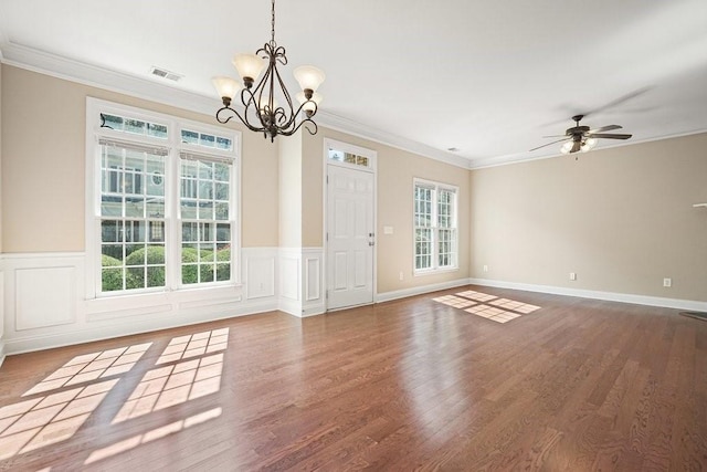 interior space with ceiling fan with notable chandelier, dark wood-type flooring, and ornamental molding