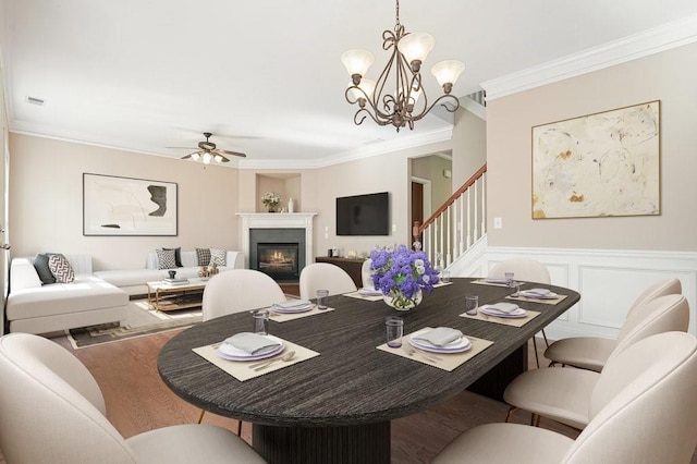 dining area featuring ceiling fan, ornamental molding, and wood-type flooring