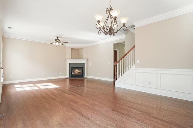 unfurnished living room with ceiling fan with notable chandelier, hardwood / wood-style floors, and crown molding