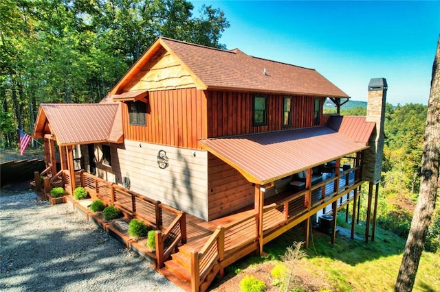 rear view of house featuring a deck