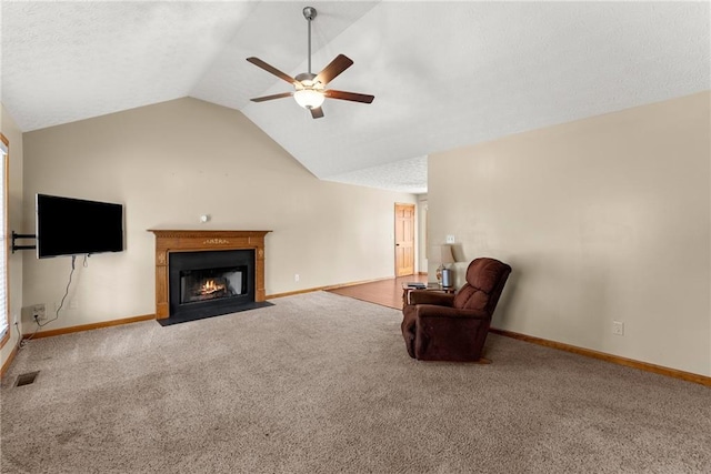 unfurnished living room featuring visible vents, a fireplace with flush hearth, carpet flooring, ceiling fan, and vaulted ceiling