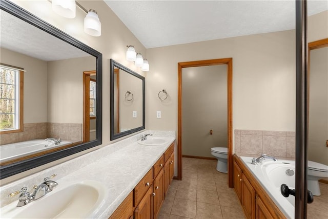 bathroom with tile patterned flooring, double vanity, toilet, and a sink