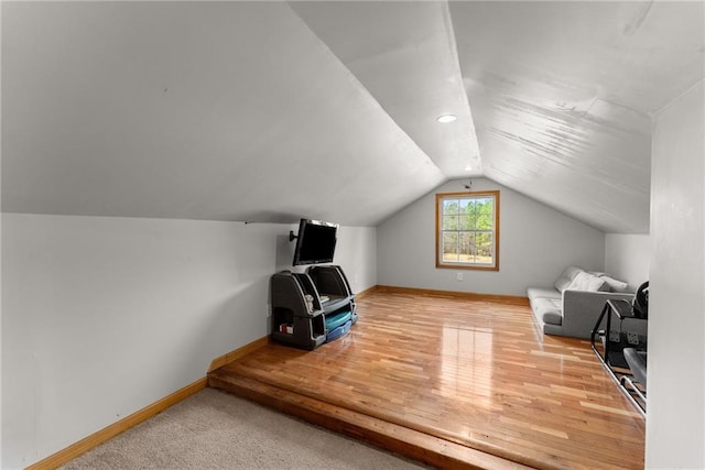 bedroom with wood finished floors, baseboards, and vaulted ceiling