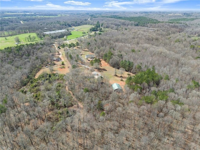 bird's eye view featuring a wooded view