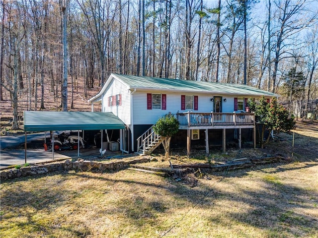 view of front of home with a carport, metal roof, stairway, and a front lawn