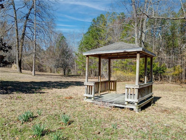 view of yard featuring a view of trees and a gazebo