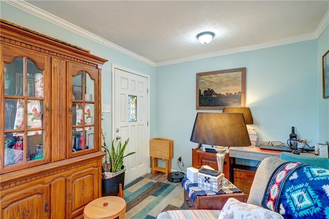 living area with crown molding and wood finished floors