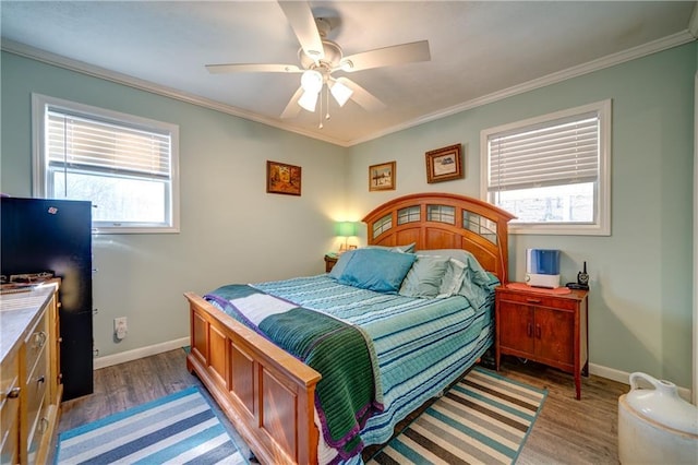 bedroom featuring ornamental molding, baseboards, and wood finished floors