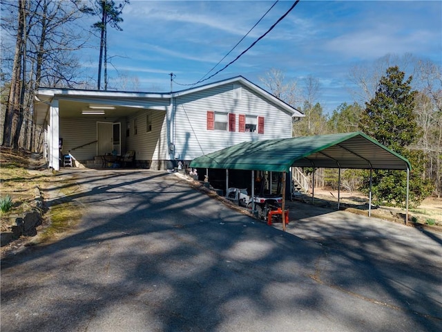 exterior space featuring aphalt driveway and a carport