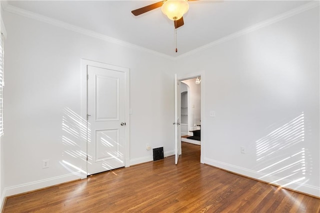 empty room with hardwood / wood-style flooring, ceiling fan, and ornamental molding