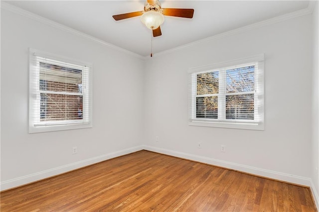 empty room featuring ornamental molding, hardwood / wood-style floors, and ceiling fan