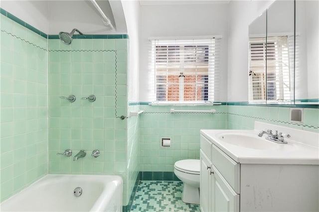 bathroom with tile walls, vanity, and toilet