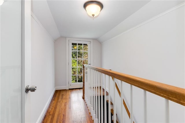 hall featuring light hardwood / wood-style flooring and vaulted ceiling