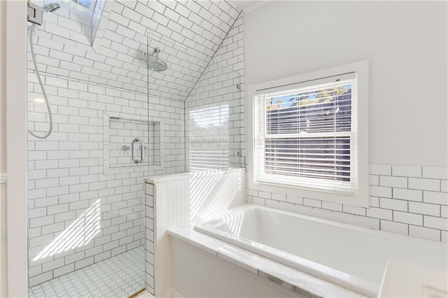 bathroom featuring shower with separate bathtub and vaulted ceiling