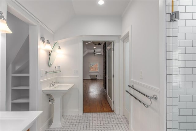 bathroom featuring walk in shower, lofted ceiling, and built in features