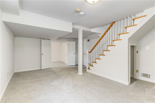 basement featuring light colored carpet