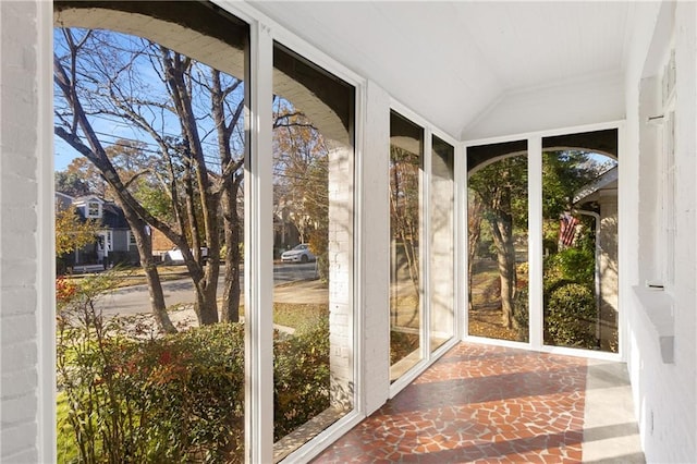 unfurnished sunroom with vaulted ceiling