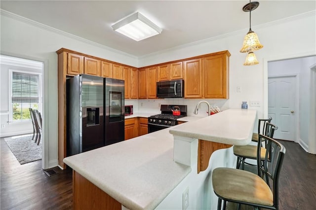 kitchen with a peninsula, light countertops, stainless steel refrigerator with ice dispenser, dark wood-style floors, and gas stove