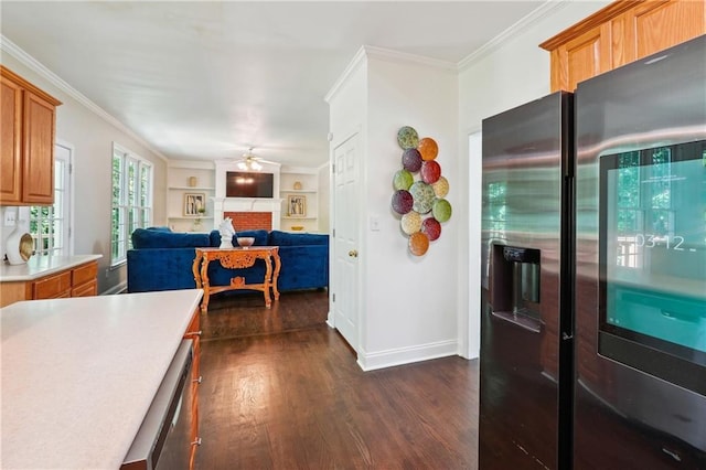 kitchen with dark wood-style floors, crown molding, light countertops, appliances with stainless steel finishes, and ceiling fan