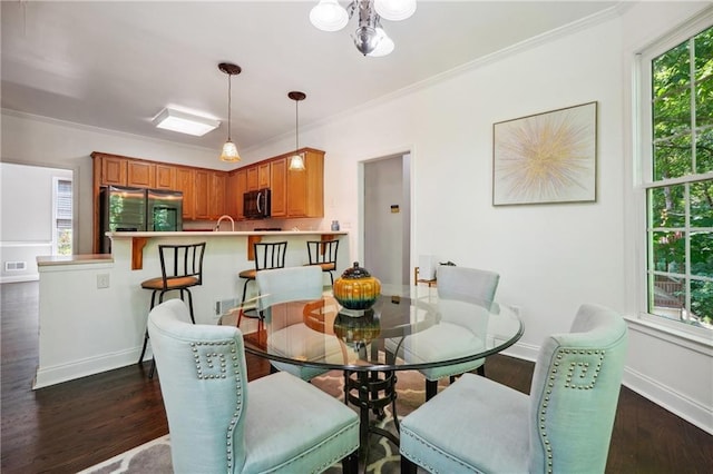 dining room with crown molding, visible vents, baseboards, and dark wood-type flooring