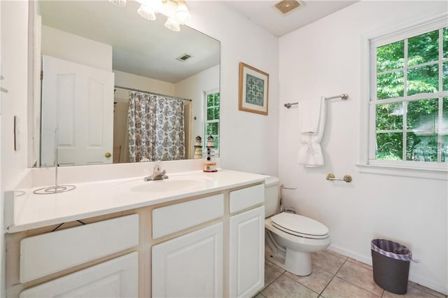 bathroom with toilet, tile patterned flooring, visible vents, and vanity