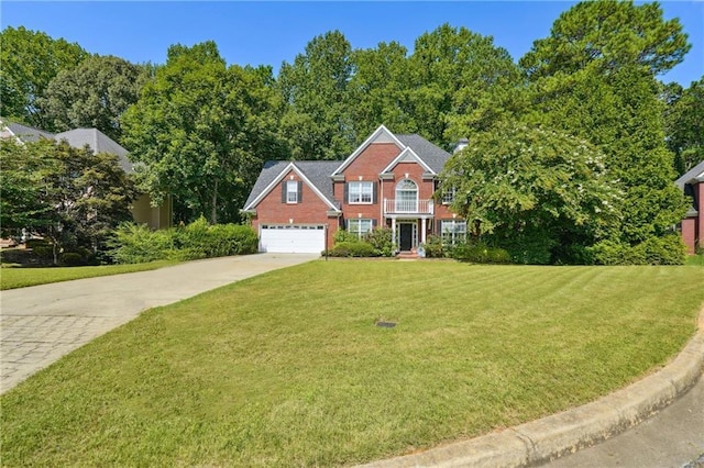 colonial house featuring a garage, driveway, brick siding, and a front yard