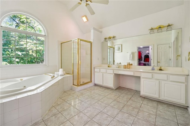 bathroom with lofted ceiling, a garden tub, a shower stall, tile patterned floors, and double vanity